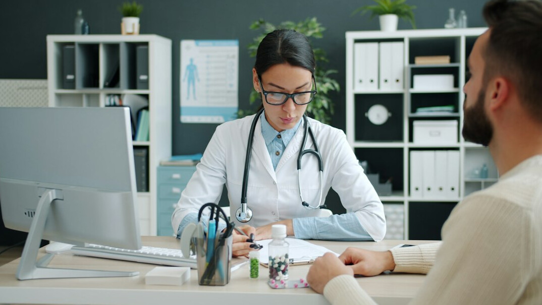 person talking to doctor in office